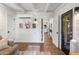 Living room with white brick walls, an exposed-beam ceiling, and doorway view at 1825 E Palo Verde Dr, Phoenix, AZ 85016