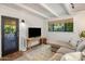 Bright living room with exposed-beam ceiling, white brick walls, and contemporary decor at 1825 E Palo Verde Dr, Phoenix, AZ 85016