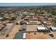 Distant aerial view highlighting the property in a vast suburban neighborhood with mountains at 19711 W Colter St, Litchfield Park, AZ 85340