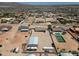 Aerial shot showing a large home with a spacious yard, garage, and surrounding neighborhood at 19711 W Colter St, Litchfield Park, AZ 85340