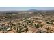 Expansive aerial view of a suburban neighborhood with mountain views in the distance, showcasing community layout at 19711 W Colter St, Litchfield Park, AZ 85340