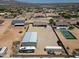 Aerial shot of the property featuring a large garage, yard, and surrounding neighborhood at 19711 W Colter St, Litchfield Park, AZ 85340