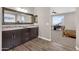 Bathroom showcasing a double vanity, a mirror, wood-look floors, and a view into the bedroom at 19711 W Colter St, Litchfield Park, AZ 85340