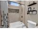 Bright bathroom featuring a shower and tub combination with decorative tile and updated fixtures at 19711 W Colter St, Litchfield Park, AZ 85340