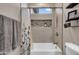 Bright bathroom featuring a shower and tub combination with decorative tile and updated fixtures at 19711 W Colter St, Litchfield Park, AZ 85340