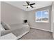 This bedroom features neutral walls and carpet, ceiling fan, and a window overlooking the community at 19711 W Colter St, Litchfield Park, AZ 85340
