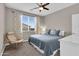 This bedroom offers a chair, ceiling fan, and large window, providing a cozy and bright atmosphere at 19711 W Colter St, Litchfield Park, AZ 85340