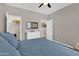 This bedroom has neutral walls and carpet with access to the closet and views to other rooms at 19711 W Colter St, Litchfield Park, AZ 85340