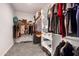 A walk-in closet with built-in shelving and hanging racks for optimal storage and organization at 19711 W Colter St, Litchfield Park, AZ 85340