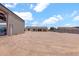 View of the property featuring a spacious gravel area, a home, and a large metal building perfect for storage at 19711 W Colter St, Litchfield Park, AZ 85340