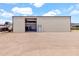 Wide property showcasing a large metal building with equipment and an RV, secured by fencing and a gravel area at 19711 W Colter St, Litchfield Park, AZ 85340