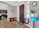 Welcoming foyer with sleek wood flooring, a decorative accent table, and stylish decor at 19711 W Colter St, Litchfield Park, AZ 85340