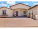 Inviting front patio featuring a charming table set, flower boxes, and custom outdoor furniture at 19711 W Colter St, Litchfield Park, AZ 85340