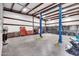 Bright garage with an Atlas car lift, toolboxes, and ample space for various projects at 19711 W Colter St, Litchfield Park, AZ 85340