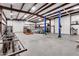 Spacious garage with a boat, tractor, car lift, and ample storage space at 19711 W Colter St, Litchfield Park, AZ 85340