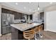 Beautiful kitchen with granite countertops, stainless steel appliances, and an island with seating at 19711 W Colter St, Litchfield Park, AZ 85340