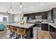 Beautiful kitchen with granite countertops, stainless steel appliances, and an island with seating at 19711 W Colter St, Litchfield Park, AZ 85340