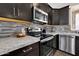 Close-up of the kitchen with granite countertops and stainless steel appliances at 19711 W Colter St, Litchfield Park, AZ 85340