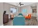 Bright living room with hardwood floors and colorful accent chairs at 19711 W Colter St, Litchfield Park, AZ 85340