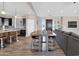 Spacious living room seamlessly connected to a modern kitchen, providing ample space to relax and entertain at 19711 W Colter St, Litchfield Park, AZ 85340