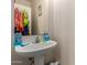 Neutral bathroom with a pedestal sink, medicine cabinet, and small framed art at 19719 N Castille Dr, Maricopa, AZ 85138