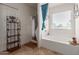Bright bathroom featuring a soaking tub, walk-in shower, and stylish decor at 19719 N Castille Dr, Maricopa, AZ 85138