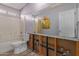 A simple bathroom featuring a toilet, bathtub and large mirror at 19719 N Castille Dr, Maricopa, AZ 85138