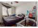 This bedroom has a ceiling fan, a window for natural light and a crib at 19719 N Castille Dr, Maricopa, AZ 85138