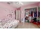 This bedroom features a tiled floor, a ceiling fan, a closet and plenty of natural light at 19719 N Castille Dr, Maricopa, AZ 85138