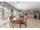Bright dining area featuring a round wood table and chairs next to a decorative curtain at 19719 N Castille Dr, Maricopa, AZ 85138