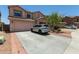 Charming two-story home features a well-manicured front yard and a spacious driveway at 19719 N Castille Dr, Maricopa, AZ 85138
