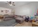 Spacious living room features tile flooring, a ceiling fan, and natural light at 19719 N Castille Dr, Maricopa, AZ 85138