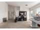 This living room features a large TV and speakers, with lots of natural light from the window at 19719 N Castille Dr, Maricopa, AZ 85138
