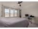Sunlit bedroom with a workspace and three large windows at 20128 W Jackson St, Buckeye, AZ 85326