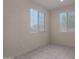 Well-lit room with two windows, tiled flooring and neutral paint, offering a bright and clean space at 20128 W Jackson St, Buckeye, AZ 85326