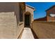 Covered entryway featuring neutral color schemes, desert landscaping, and an arched entryway at 20128 W Jackson St, Buckeye, AZ 85326