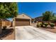 Single-story home featuring a two-car garage, desert landscaping, and a neutral color scheme at 20128 W Jackson St, Buckeye, AZ 85326