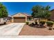 Charming single-story home featuring a two-car garage, desert landscaping, and a neutral color scheme at 20128 W Jackson St, Buckeye, AZ 85326
