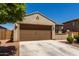 Single-story home featuring a two-car garage, desert landscaping, and a neutral color scheme at 20128 W Jackson St, Buckeye, AZ 85326