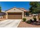 Single-story home featuring a two-car garage, desert landscaping, and a neutral color scheme at 20128 W Jackson St, Buckeye, AZ 85326