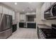 Kitchen featuring stainless steel appliances, contrasting cabinets, and an open layout, combining style with functionality at 20128 W Jackson St, Buckeye, AZ 85326