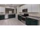Modern kitchen featuring stainless steel appliances, stylish cabinetry, and ample counter space for cooking and entertaining at 20128 W Jackson St, Buckeye, AZ 85326