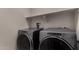 Convenient laundry room featuring modern gray washer and dryer units at 20128 W Jackson St, Buckeye, AZ 85326
