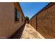 Narrow side yard with block fence and walkway at 20128 W Jackson St, Buckeye, AZ 85326