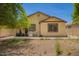 Back exterior view of home with patio and grill; backyard xeriscaped with potential at 205 N 107Th Dr, Avondale, AZ 85323