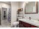 Bathroom features a quartz countertop, subway tile backsplash, and updated fixtures at 205 N 107Th Dr, Avondale, AZ 85323