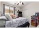Bright bedroom featuring a ceiling fan, window, and cozy decor at 205 N 107Th Dr, Avondale, AZ 85323