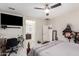 Comfortable bedroom showcasing lots of space, adjacent to a bathroom, with a ceiling fan, and a workspace at 205 N 107Th Dr, Avondale, AZ 85323