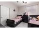 Shared bedroom with two beds, tile floors, and natural light at 205 N 107Th Dr, Avondale, AZ 85323