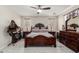 Bright and airy bedroom with hardwood flooring, decorative furniture, and stylish ceiling fan at 205 N 107Th Dr, Avondale, AZ 85323
